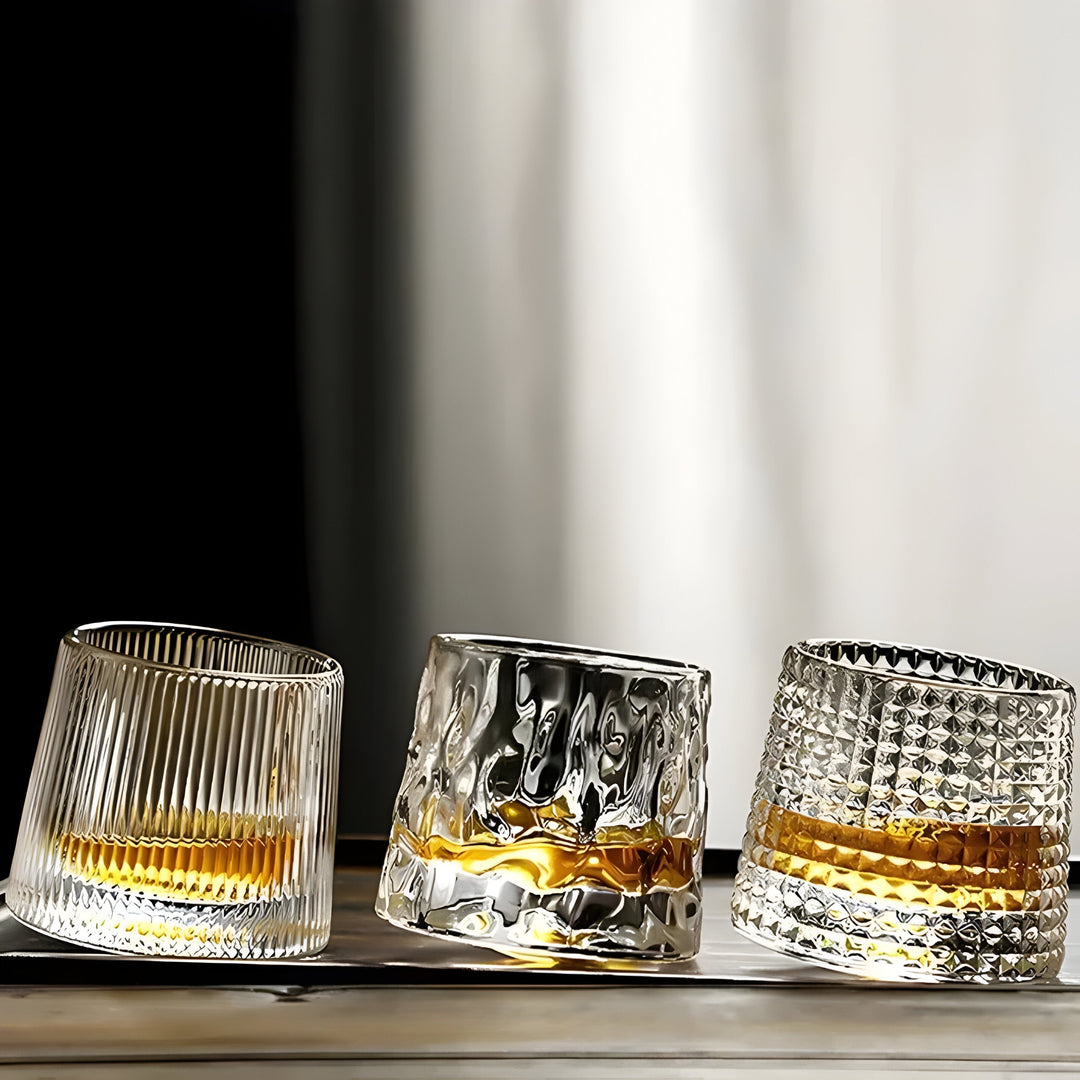 Textured 360° rotating crystal whisky glass, ideal for spirits & cocktails. Unique tasting barware.
