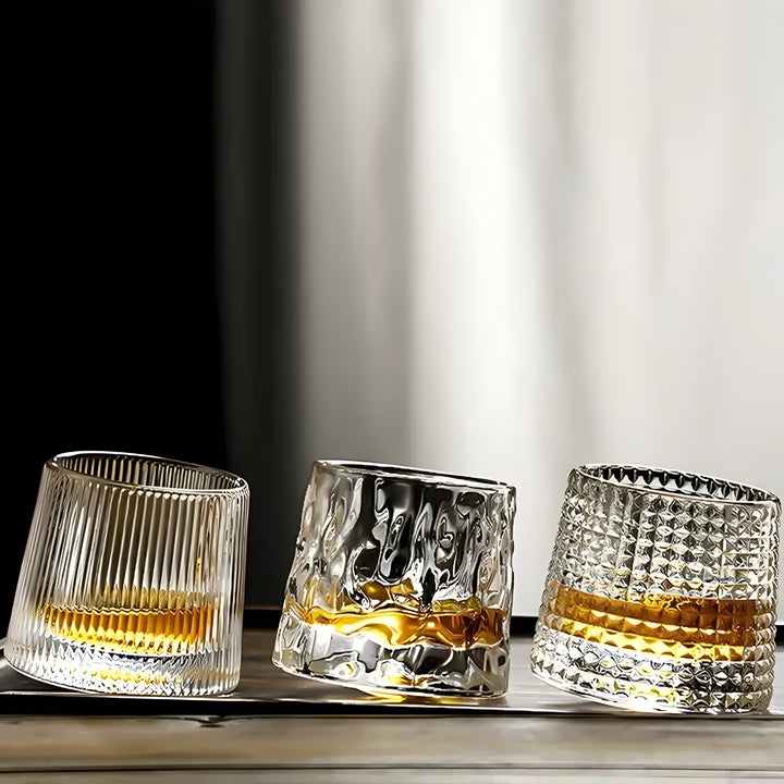 Textured 360° rotating crystal whisky glass, ideal for spirits & cocktails. Unique tasting barware.