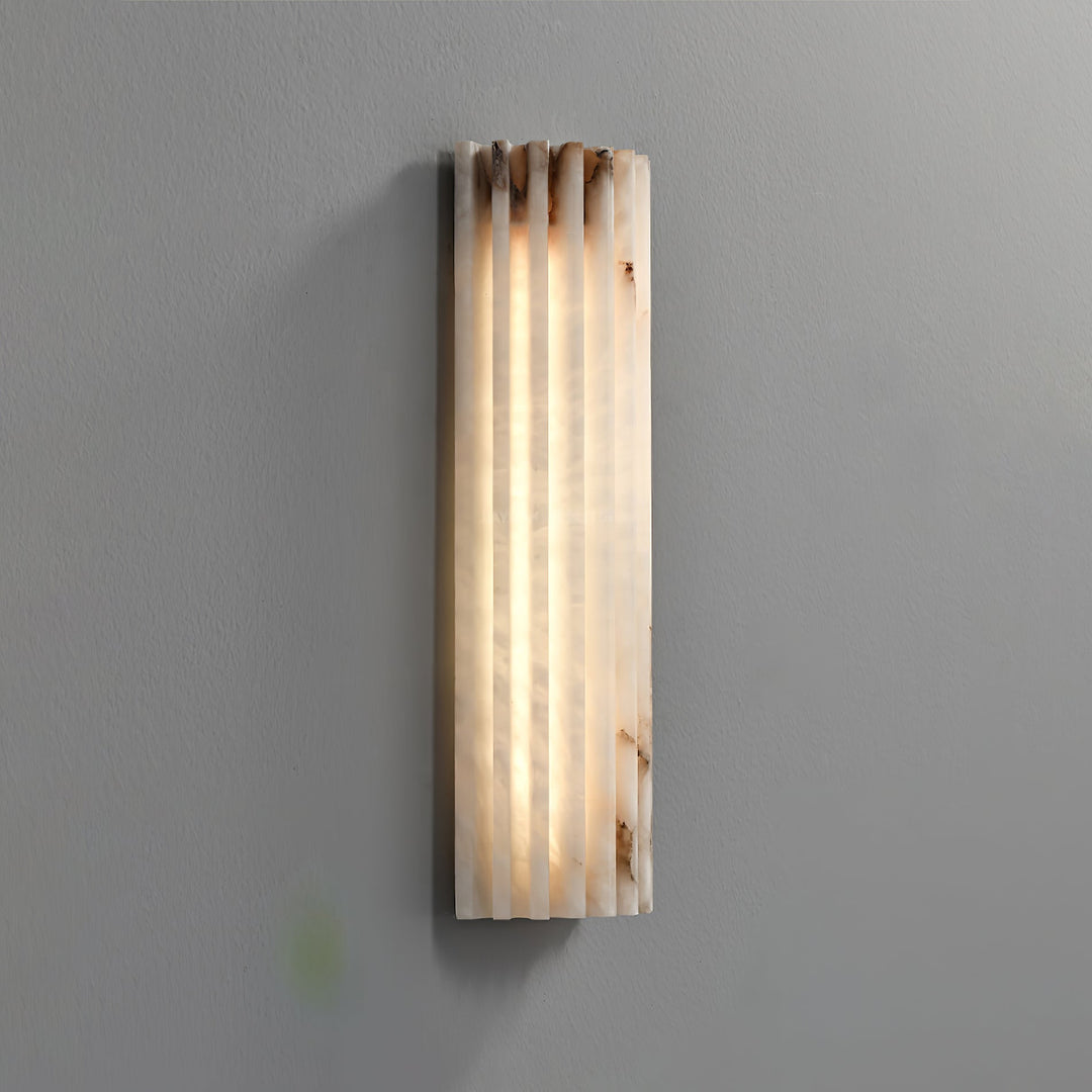 Minimalist alabaster wall sconce with LED lighting, a modern design for sophisticated interiors.