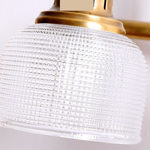 Elegant antique brass indoor wall sconce with textured glass for modern classic homes.