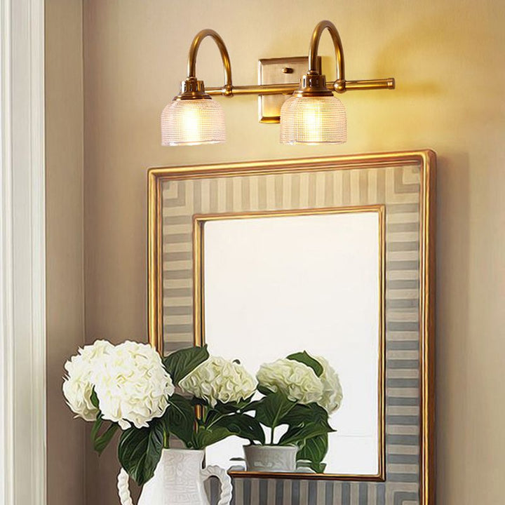Elegant antique brass wall light, a decorative indoor sconce with warm, diffused illumination.