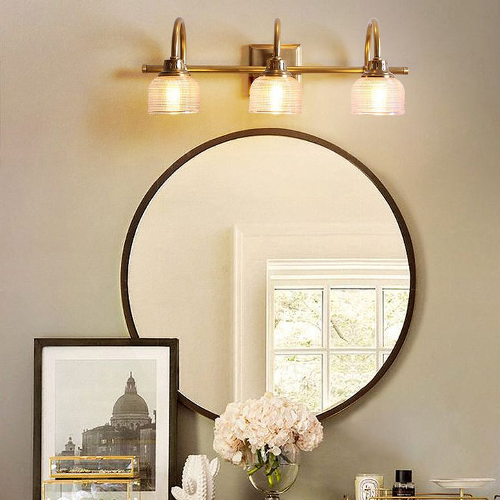 Modern classic antique brass wall lamp with textured glass, enhancing elegant home decor.