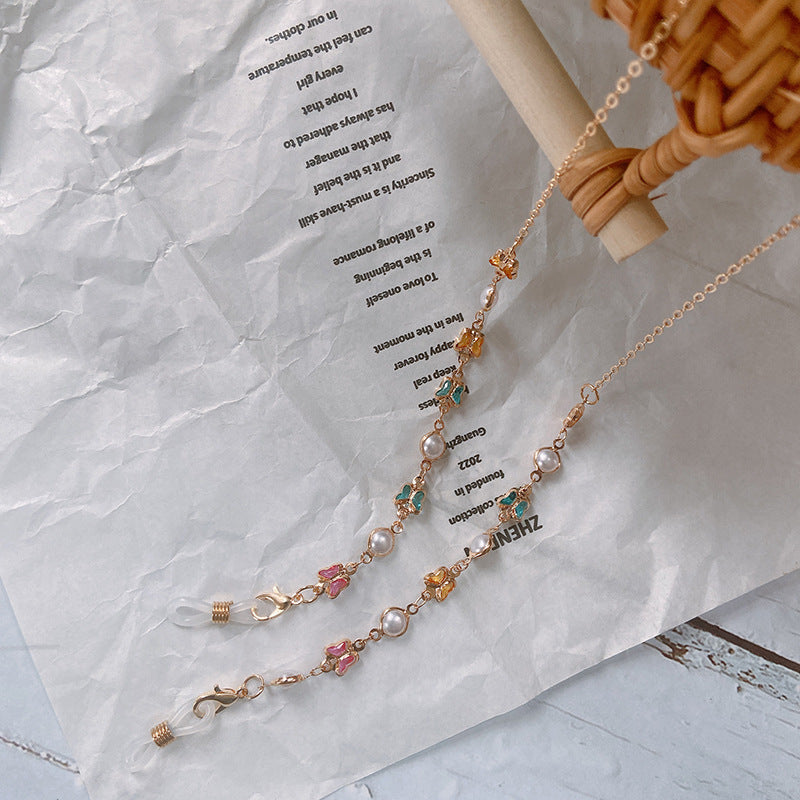 Elegant beaded glasses chain for women with stylish charms. Secure eyewear holder & fashion accessory.