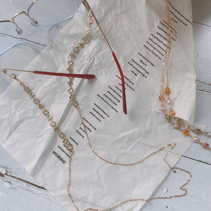 Close-up of women's elegant beaded spectacle lanyard with intricate charms & secure loops.