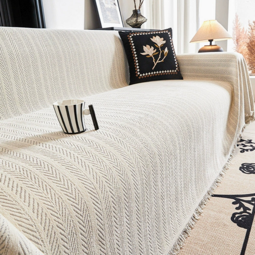 Soft green herringbone chenille sofa cover with tassels. Stylish furniture protector & home decor throw for living room.