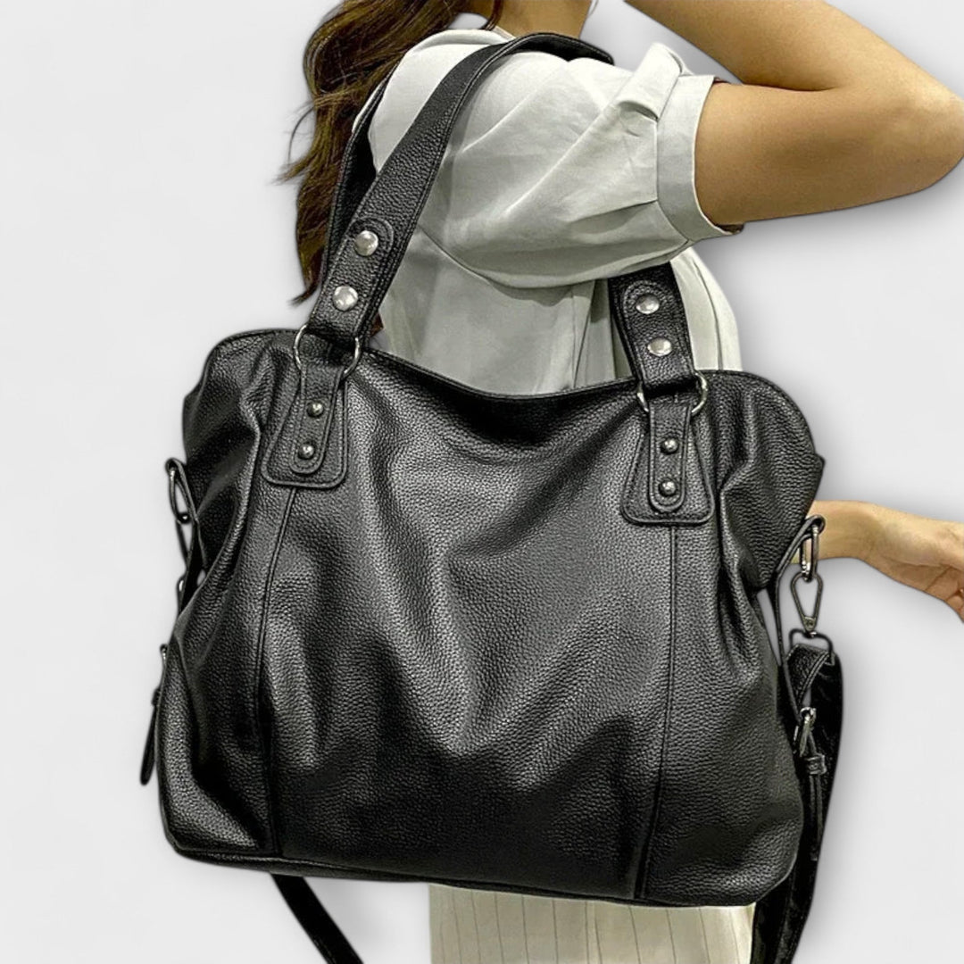 Stylish black women's hobo bag, perfect as a shoulder or crossbody bag. Chic fashion accessory.