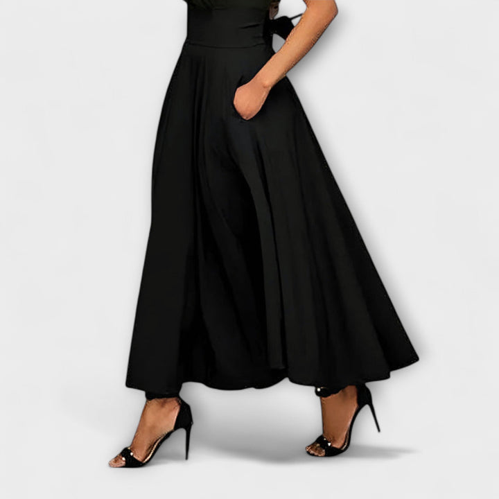 Elegant black flowing maxi skirt for women, perfect for evening wear or chic party style.