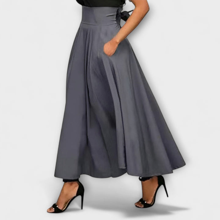 Versatile grey flowing maxi skirt, ideal for women's fashion, suitable for day or evening wear.