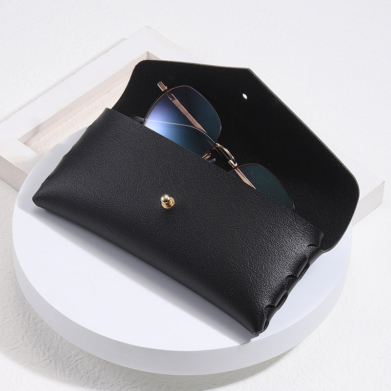 Elegant black leather minimalist phone case with snap closure, unisex card holder & wallet function.