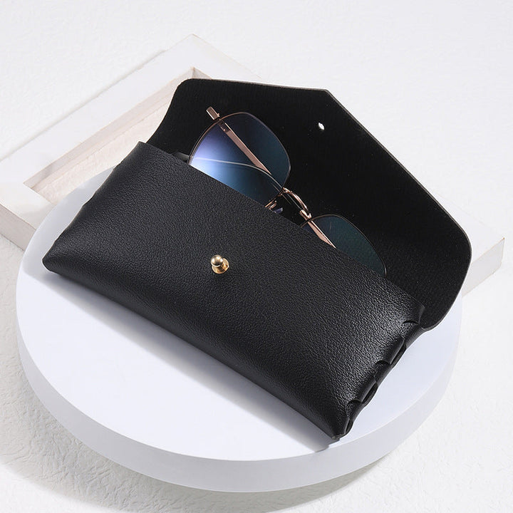 Elegant black leather minimalist phone case with snap closure, unisex card holder & wallet function.