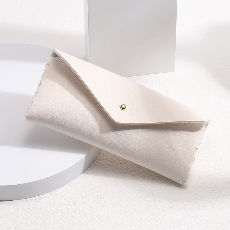 Minimalist leather phone wallet case with card holder, snap closure, and elegant design for everyday carry.