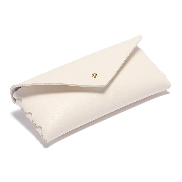 Stylish leather phone case with minimalist design, snap closure, integrated card holder & wallet for everyday essentials.