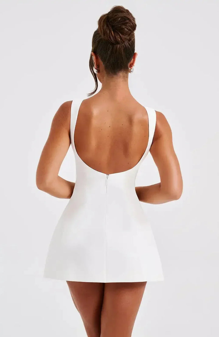 Stylish women's black & white A-line mini dress featuring a classic boat neck. Chic and versatile.