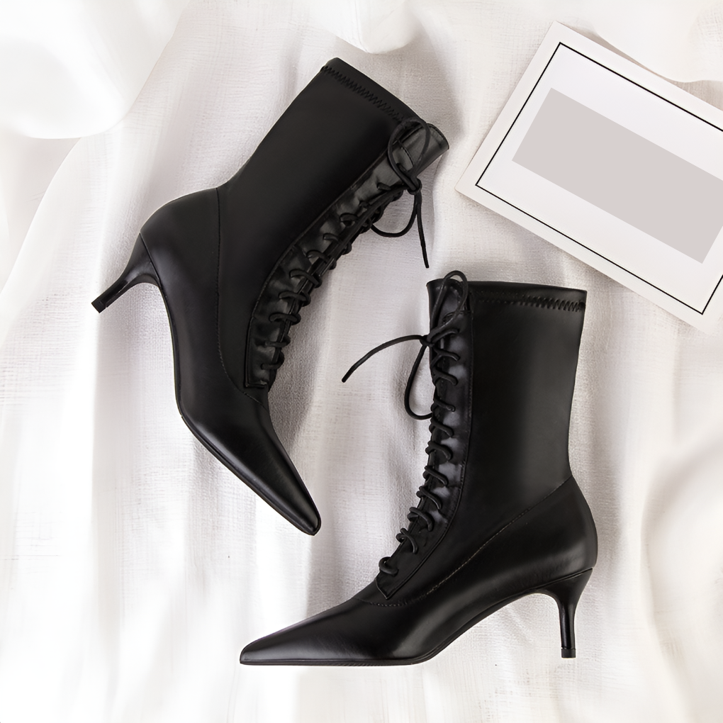 Elegant black women's boots with block heel, round toe, and zipper, offering stylish comfort for fall/winter.