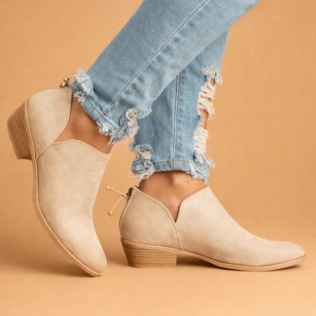 Elegant black women's slip-on ankle boots with a comfortable heel, perfect for stylish autumn and winter outfits.