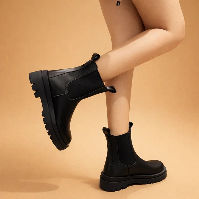 Elegant black women's slip-on high boots for versatile style & all-day comfort. Perfect fashion footwear.