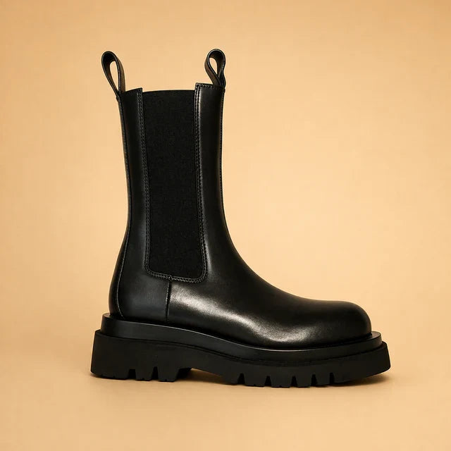 Comfortable slip-on high boots for women. Elegant black footwear, ideal for versatile everyday fashion.