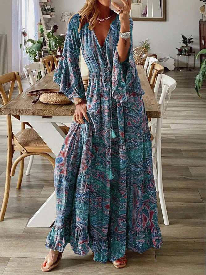 Women's flowy maxi dress with intricate paisley print and stylish flared sleeves.