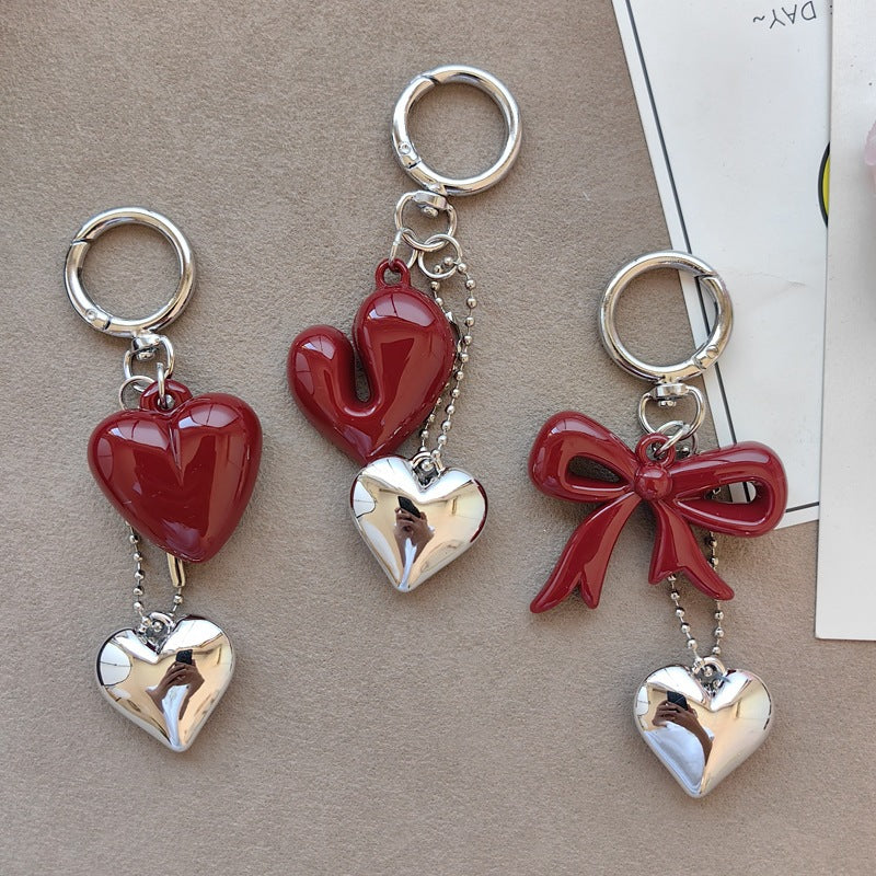 Elegant bow & heart women's keychain accessory. Perfect for keys, bags, or as a charming gift.