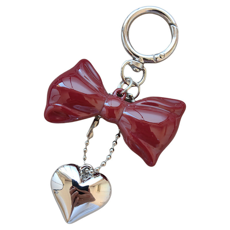 Charming women's bow and heart keychain accessory, a delightful addition to any bag or set of keys.