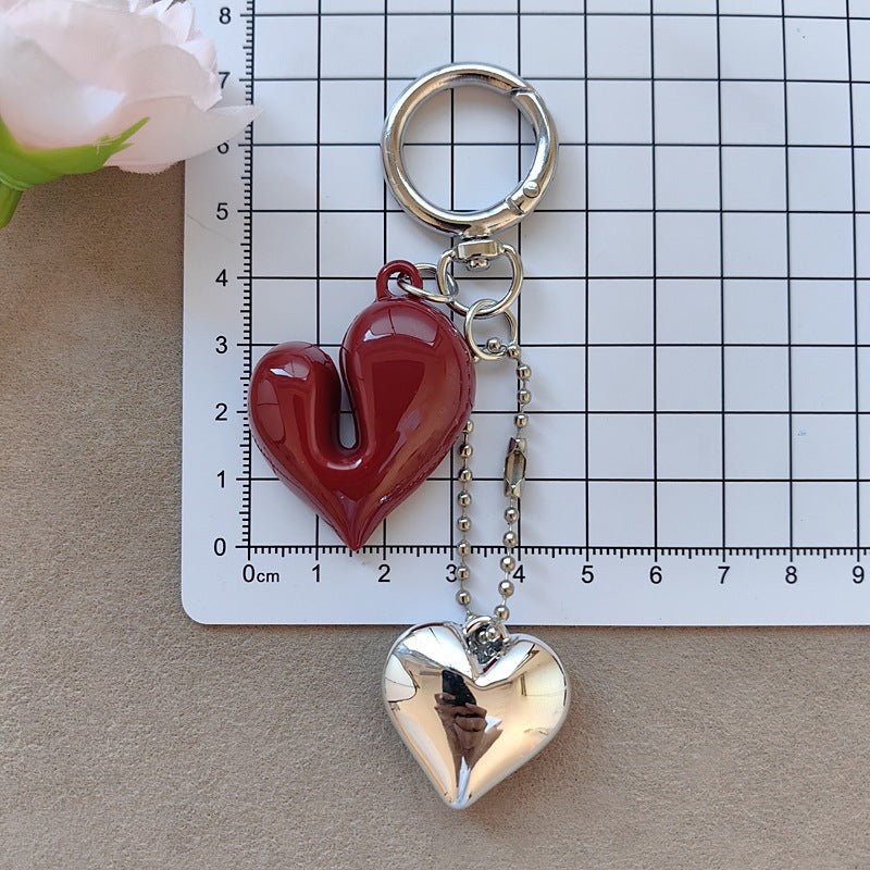 Sophisticated women's bow & heart charm keychain. Elegant accessory for keys, bags, or a thoughtful gift.