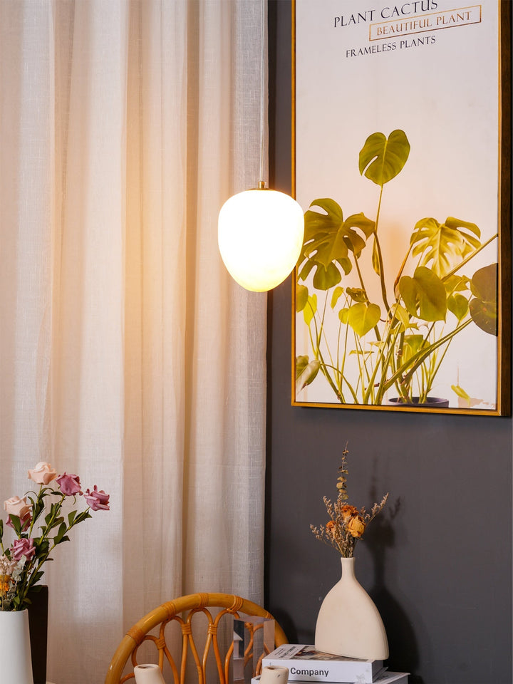 Modern ceiling light, brass pebble design, adds sophistication to contemporary decor.