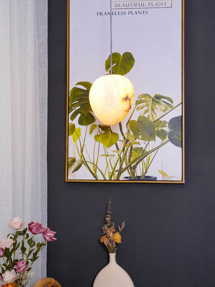 Brass pebble pendant lamp, elegant and serene, ideal for modern home ambient lighting.