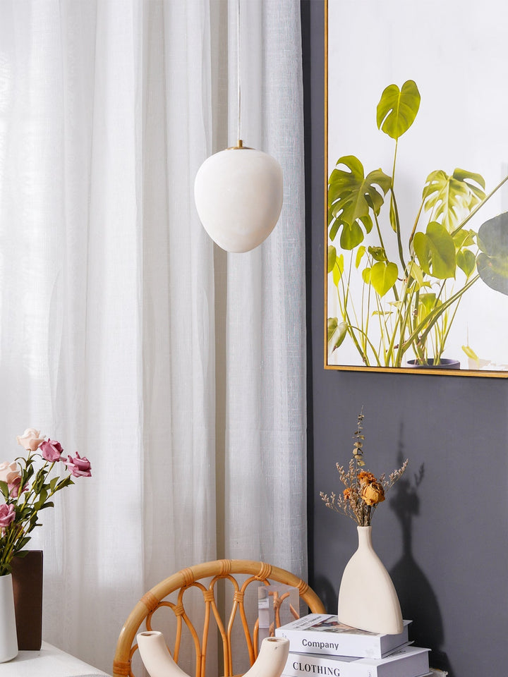 Organic design brass pendant light, pebble shape, a minimalist and contemporary fixture.