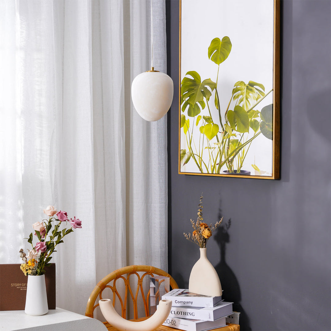 Contemporary brass ceiling light, pebble design, enhances any modern decor setting.