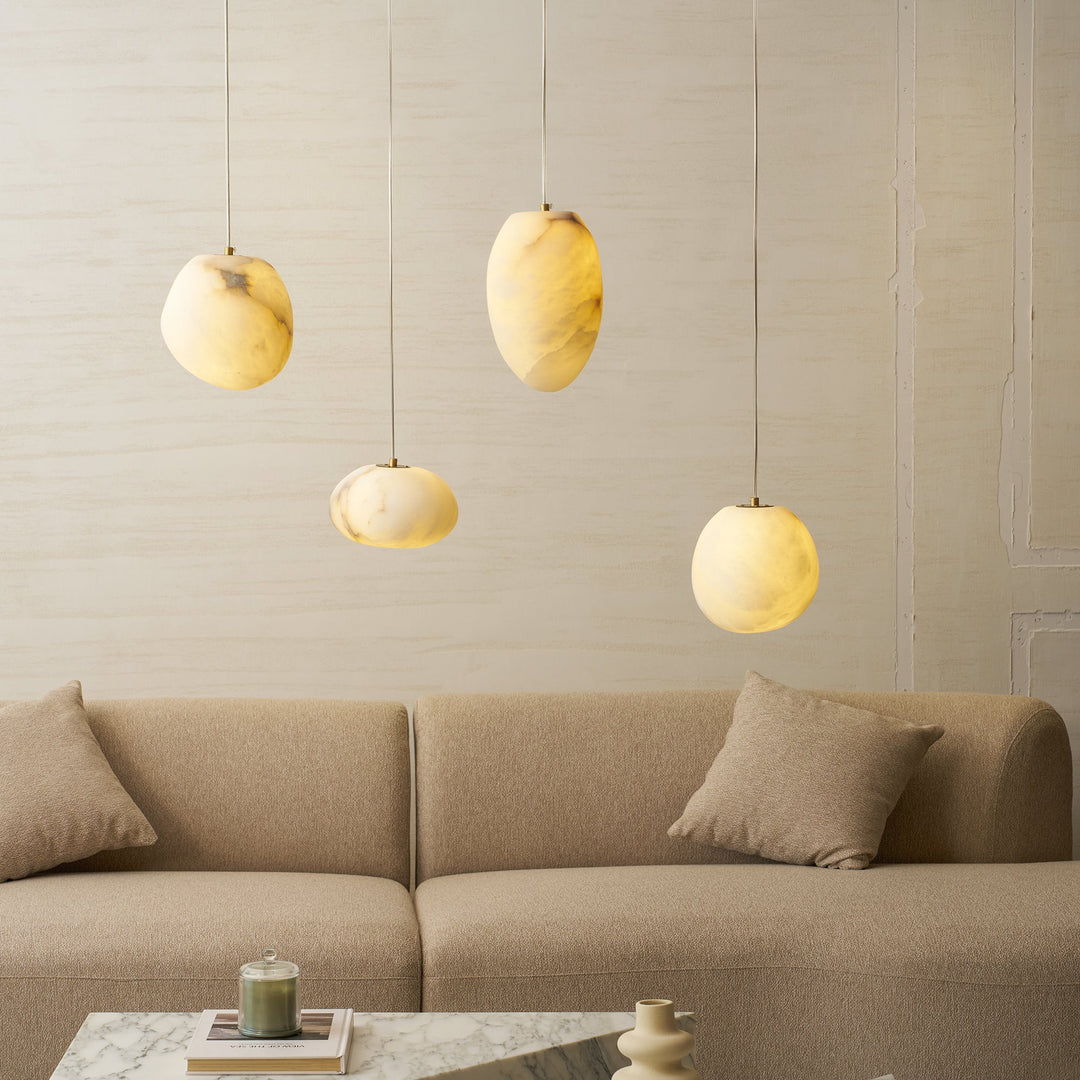 Organic pebble ceiling light in brass, minimalist home decor with ambient lighting.