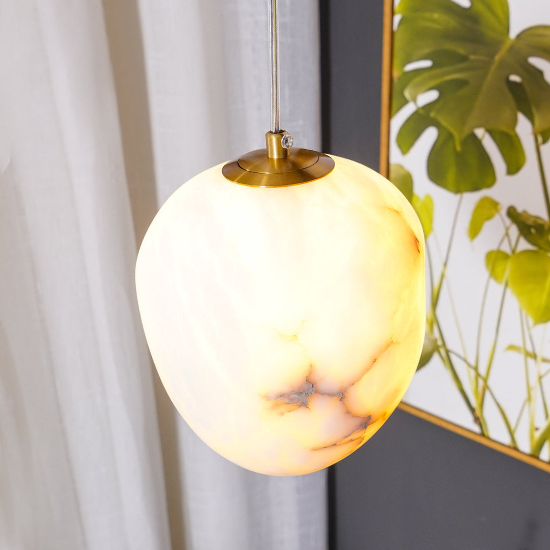 Minimalist brass pebble pendant light, perfect for adding an elegant touch to rooms.