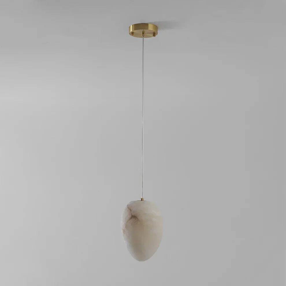 Elegant brass pebble light fixture, contemporary design for serene living spaces.