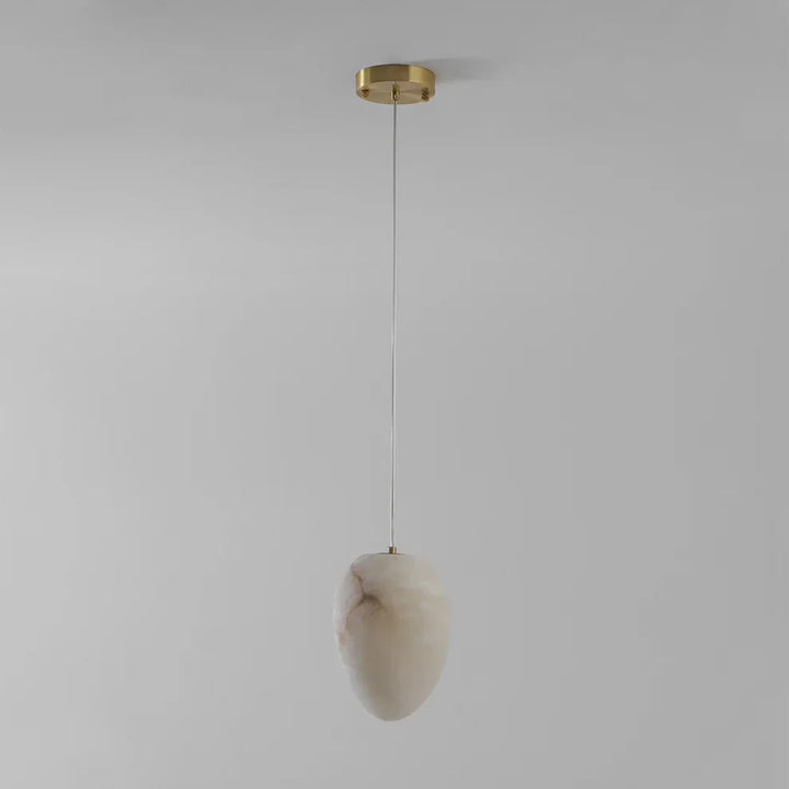 Elegant brass pebble light fixture, contemporary design for serene living spaces.