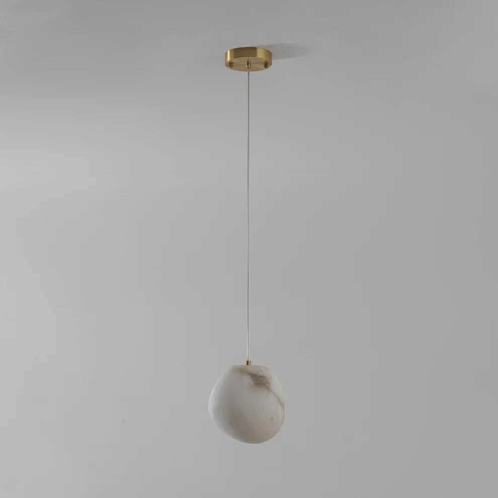 Ambient brass pendant light, pebble shape, ideal for modern home decor aesthetics.