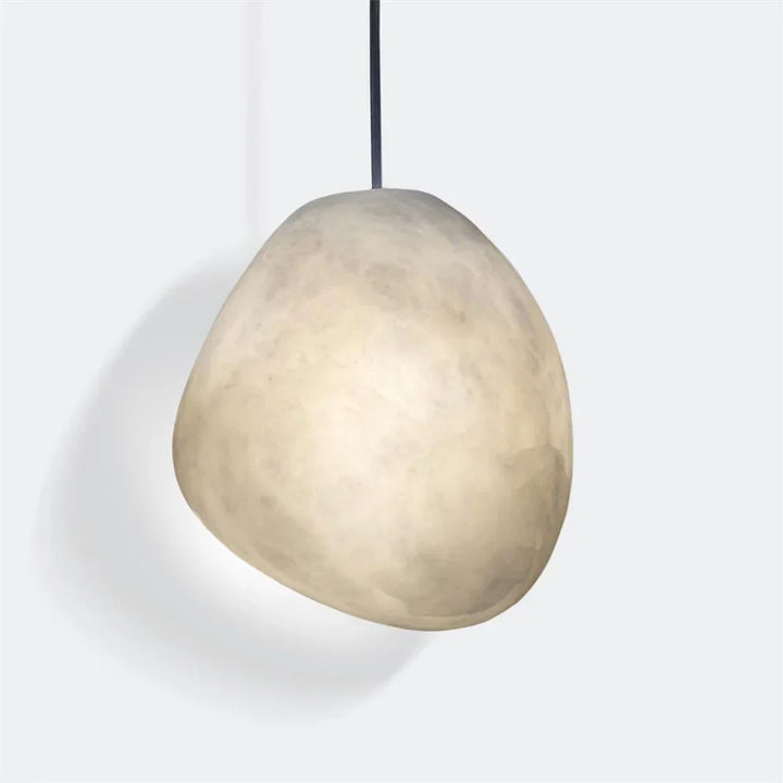 Organic brass pebble ceiling light, minimalist design, provides a serene atmosphere.