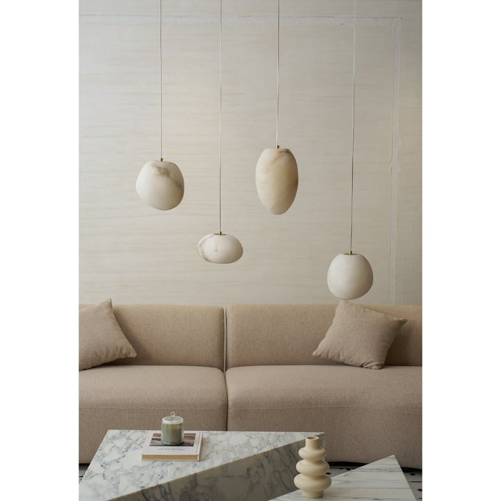 Modern brass pebble light, contemporary decor, adds a touch of elegance to interiors.