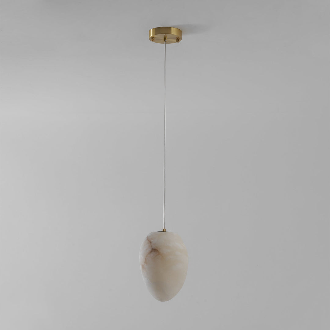 Serene interior brass pebble pendant, modern minimalist design, high-quality lighting.