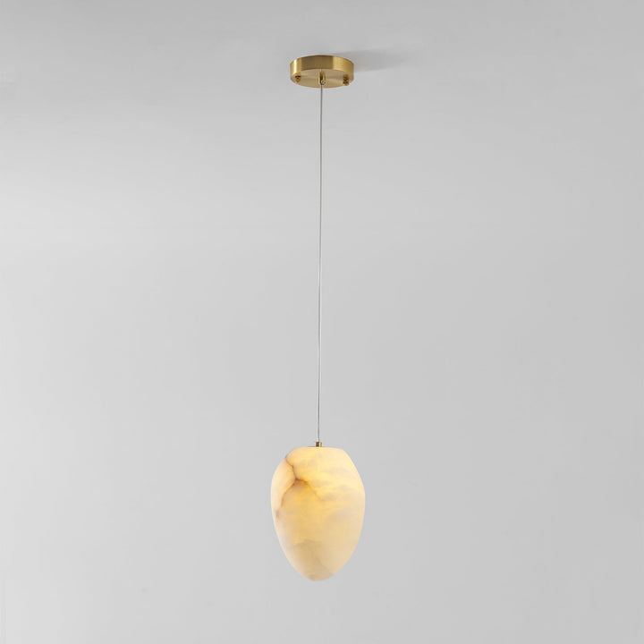 Elegant brass pebble pendant light, organic form, ideal for minimalist ambient lighting.