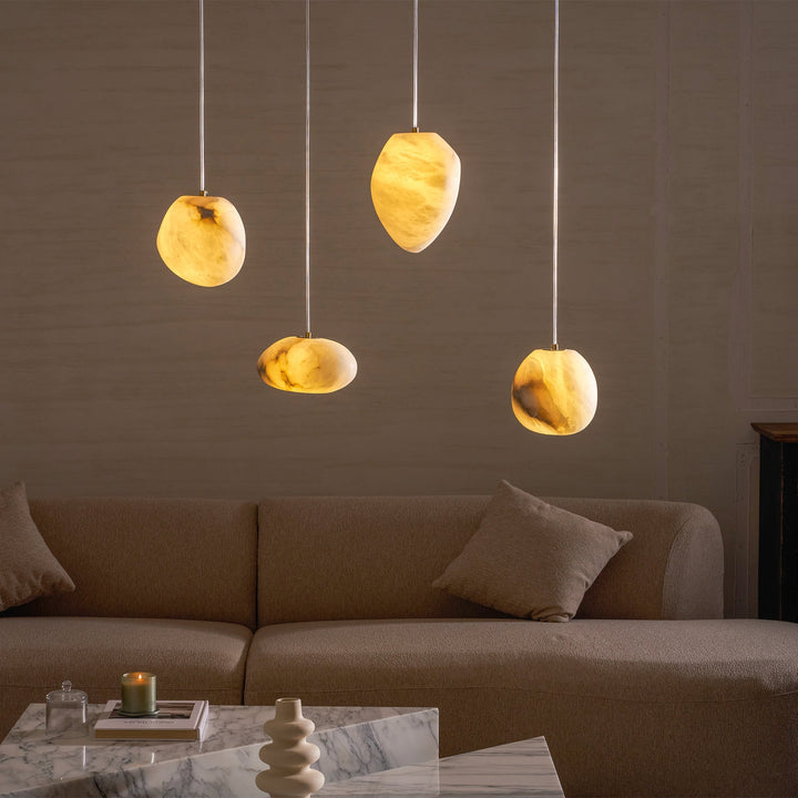 Sleek brass pebble pendant light, delivers soft ambient light for a serene home.