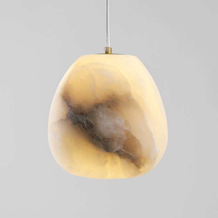 Minimalist brass pebble pendant lamp, organic design, offers sophisticated ambient light.
