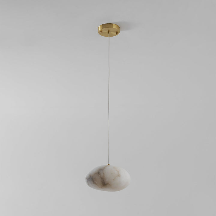 Elegant brass pebble fixture, modern and minimalist, for stunning ambient home lighting.