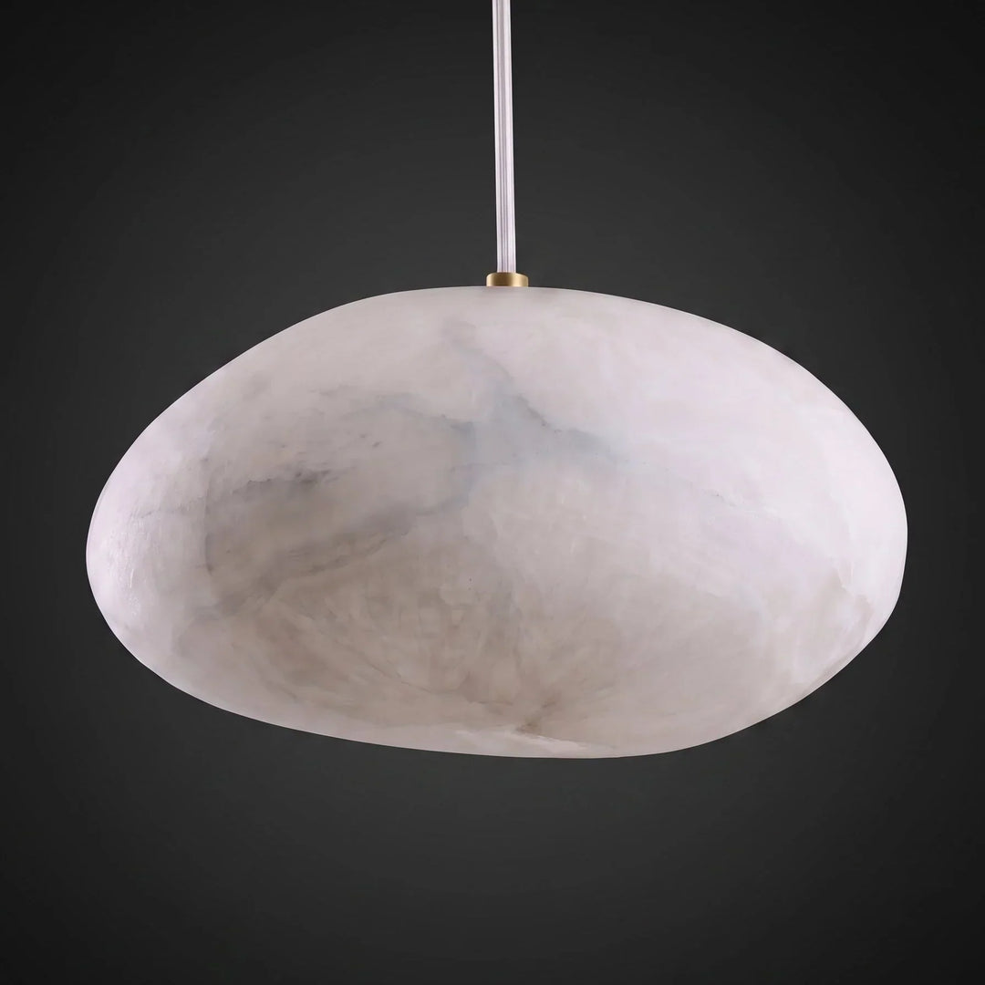 Elegant brass pebble pendant, modern decor, creates a warm and ambient atmosphere.