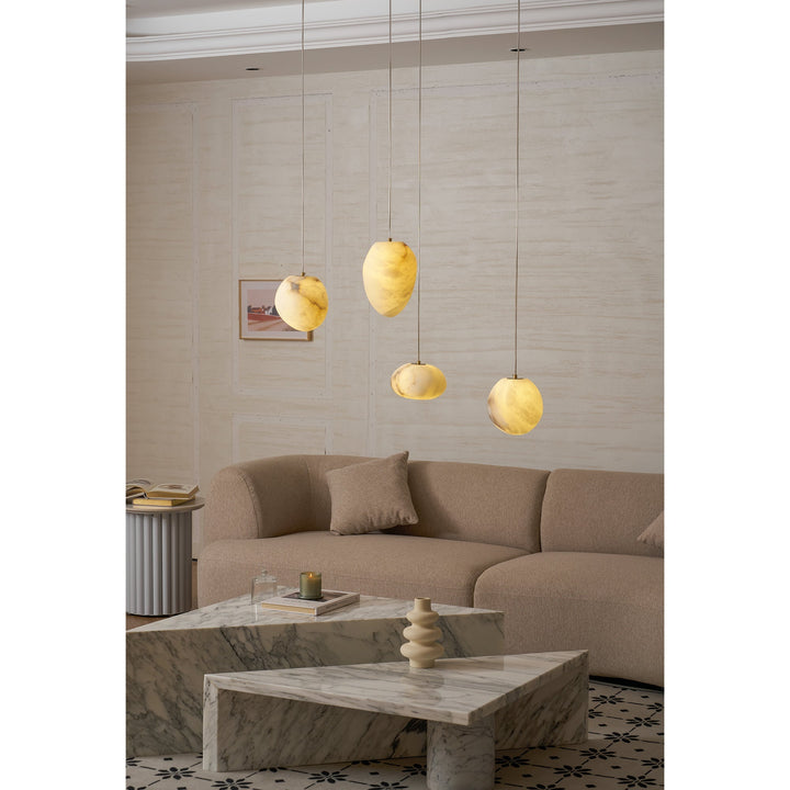 Minimalist brass pendant light, elegant pebble design, ideal modern ceiling fixture.