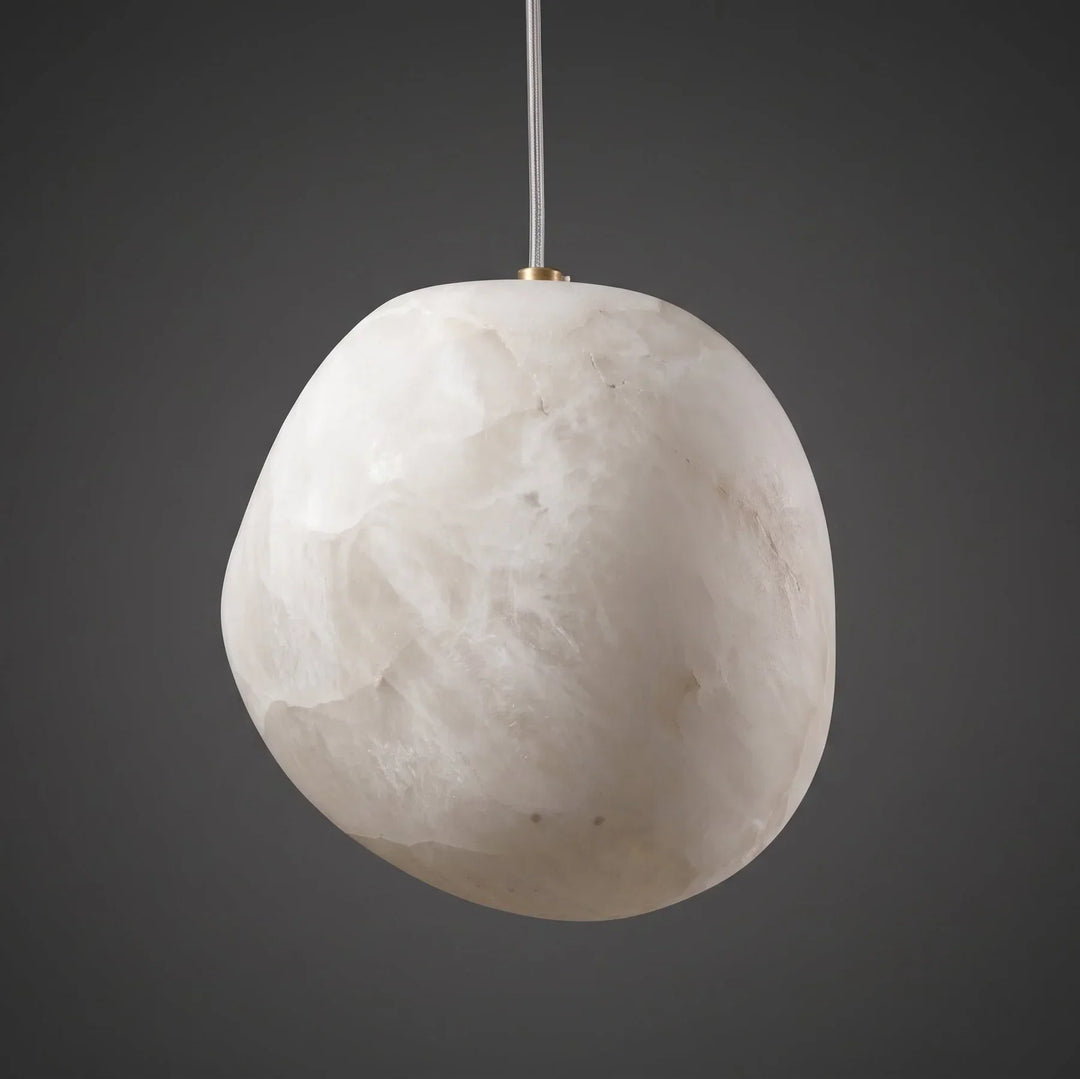 Modern brass pebble pendant, elegant organic form, for sophisticated ambient lighting.