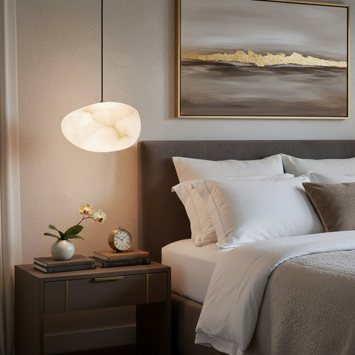 Ambient brass pebble pendant lamp, stylish modern decor, perfect for living spaces.