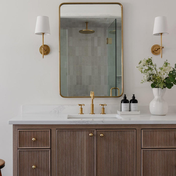 Chic Brass wall light with fabric shade for a sophisticated living room.