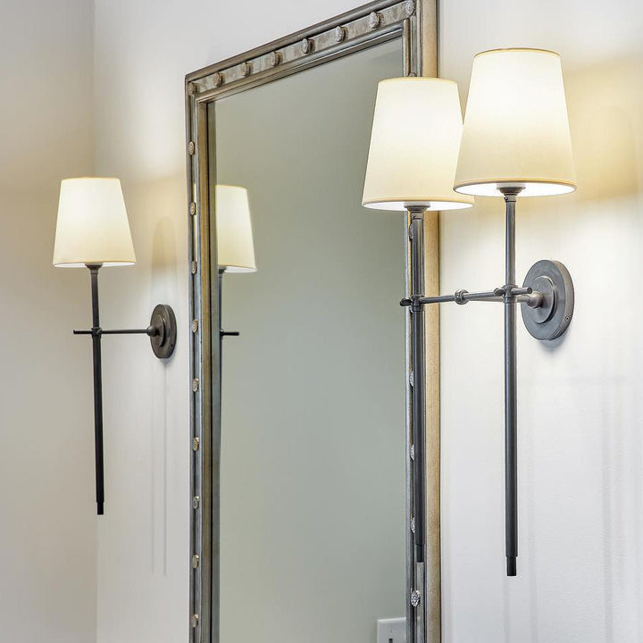 Stylish Brass wall light fixture with drum shade for elegant hallway illumination.