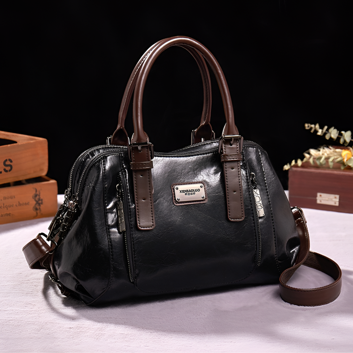 Stylish black genuine leather Boston bag for women, a classic everyday shoulder and crossbody handbag.