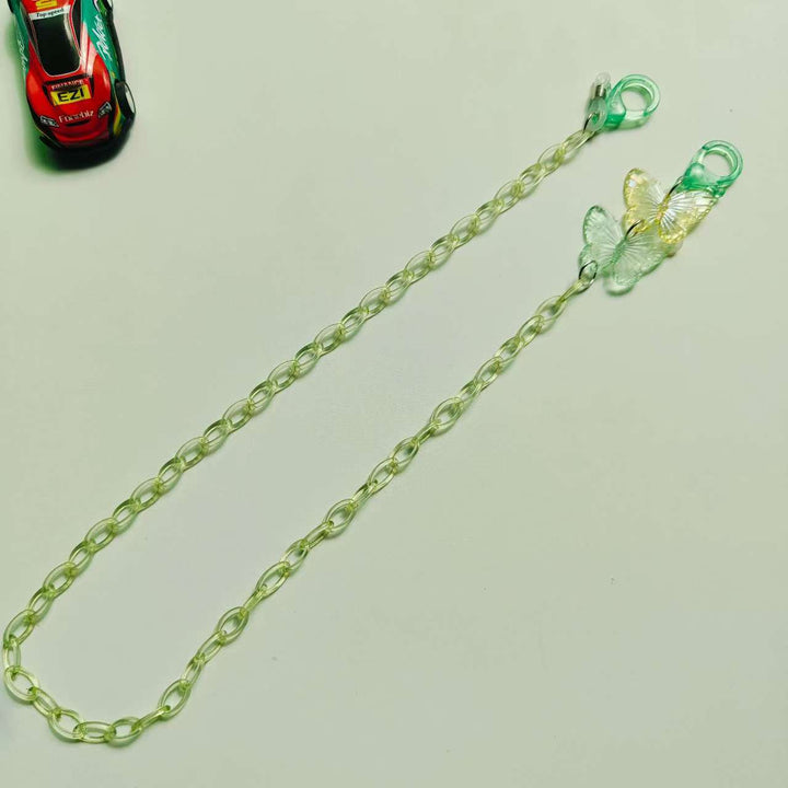 Sunny yellow butterfly necklace and glasses chain, an elegant statement piece, adds a pop of color.