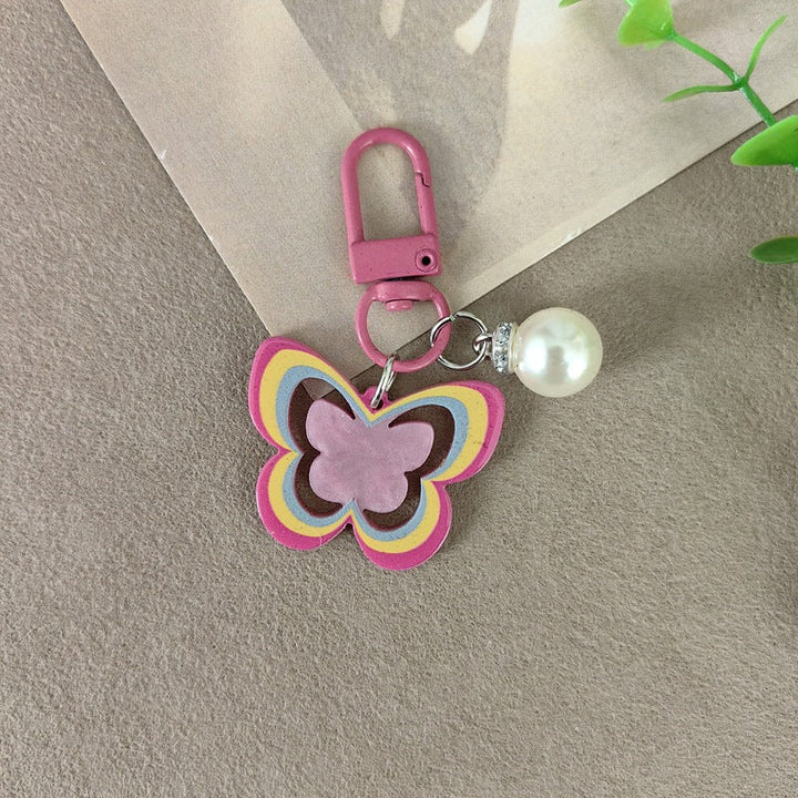 Chic butterfly and pearl keychain, a versatile women's accessory and elegant gift idea.